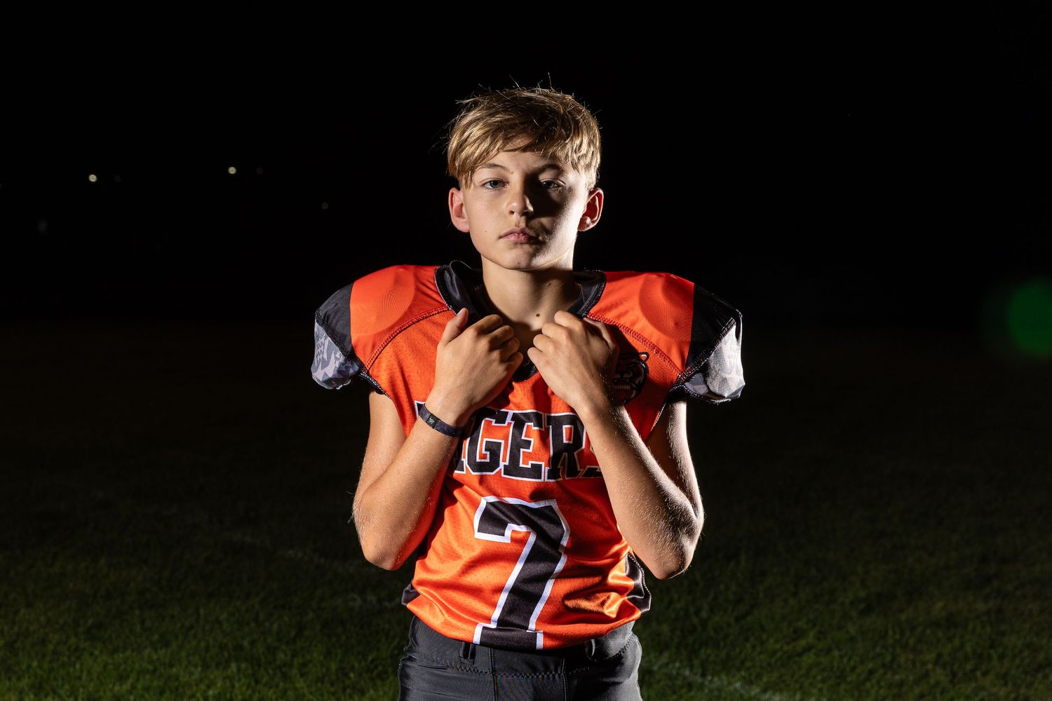 Farmington Tigers youth football player dynamic lighting sportrait twin cities sports photographer Brody Verch-Brown