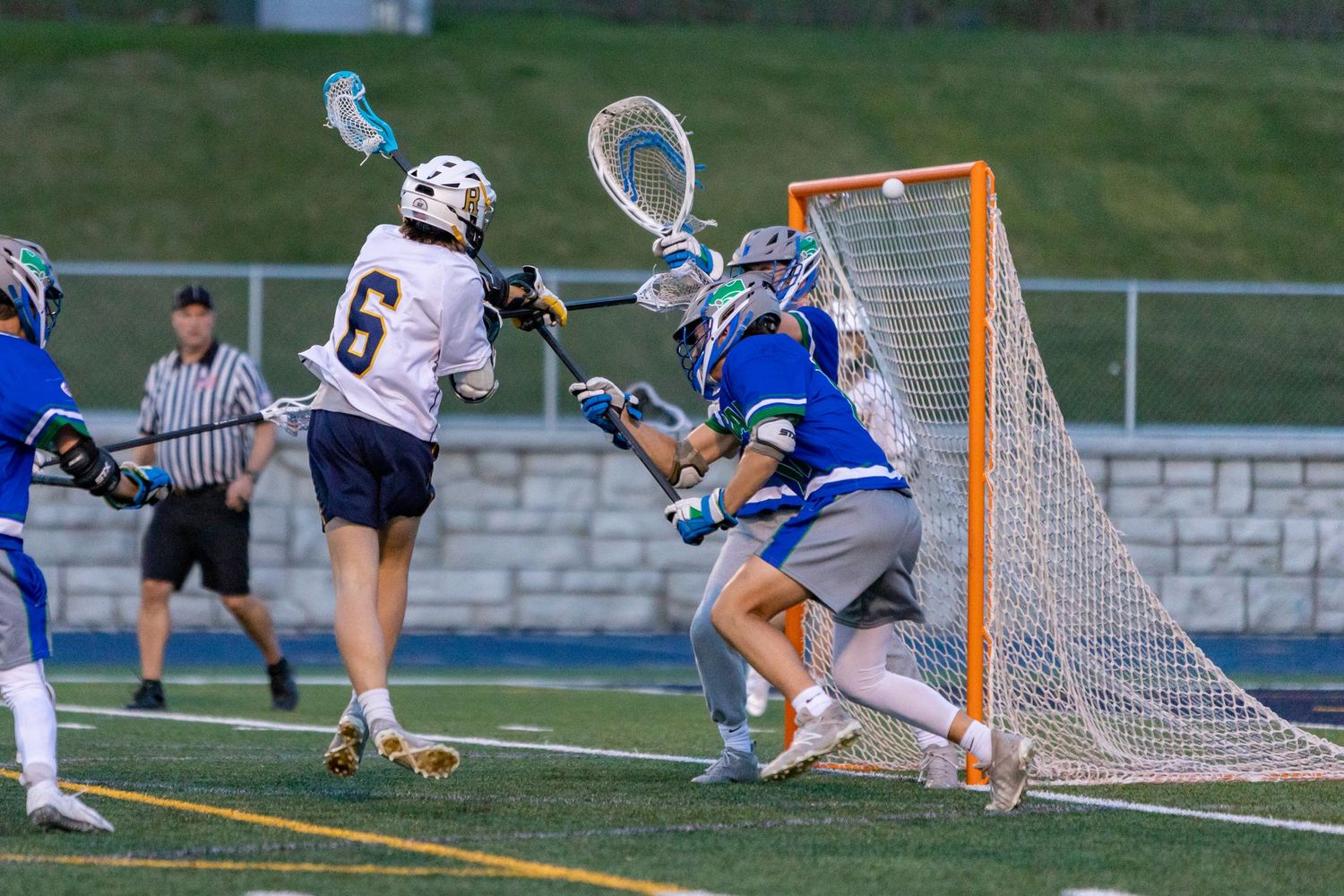 Rosemount Irish lacrosse player makes a jumping shot to score a goal