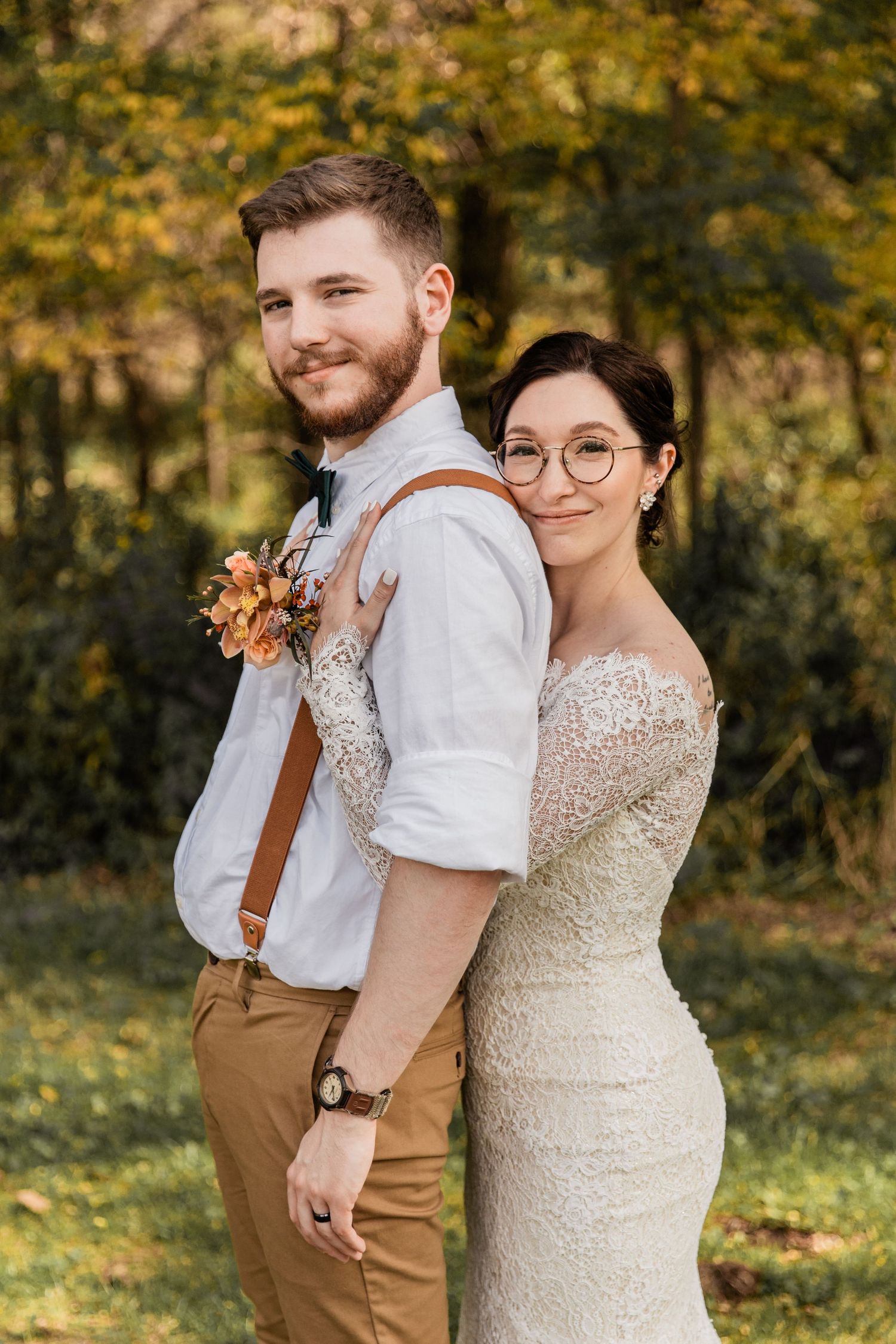 bride lays her head on her groom's back