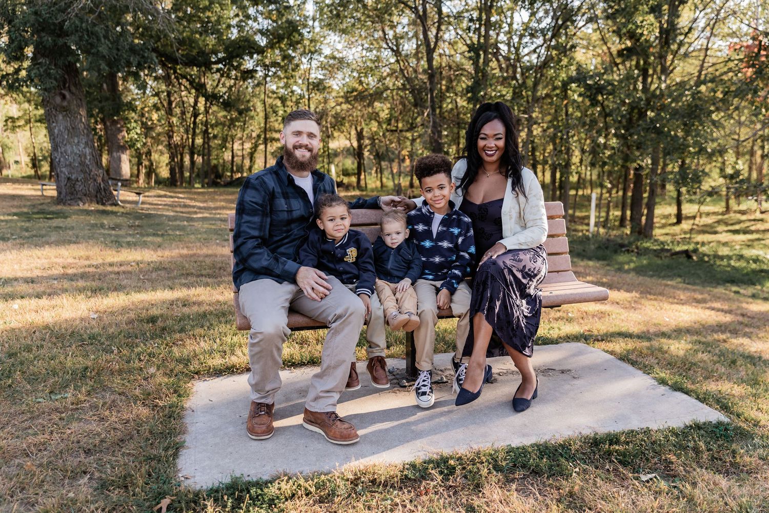 Carlson family squeezes in on a bench surrounded by beautiful fall colors