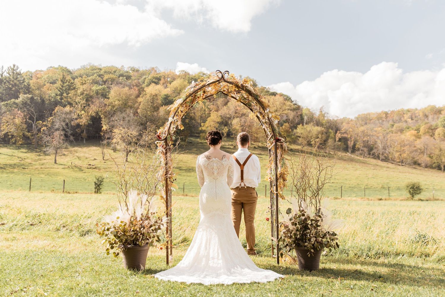 bride anxiously waiting for her groom to get his first look at her at scenic outdoor venue Briggs Outdoors in Winona MN