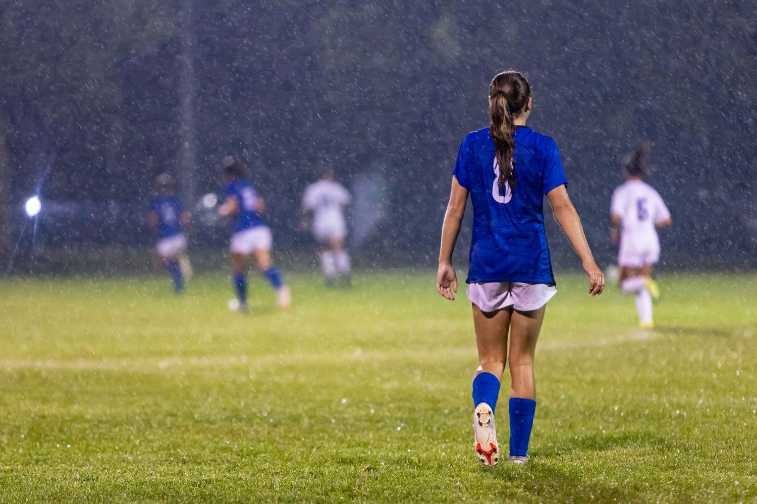 eastview high school girls soccer player getting soaked playing in the rain