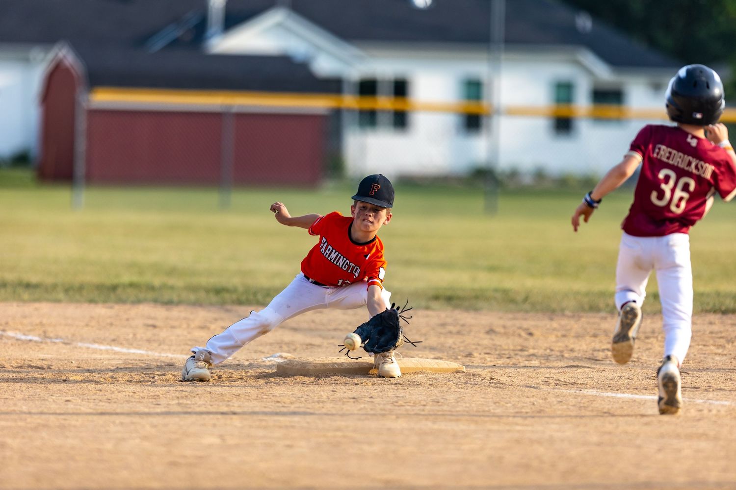 Youth baseball player reaches out to make the tag out at second base