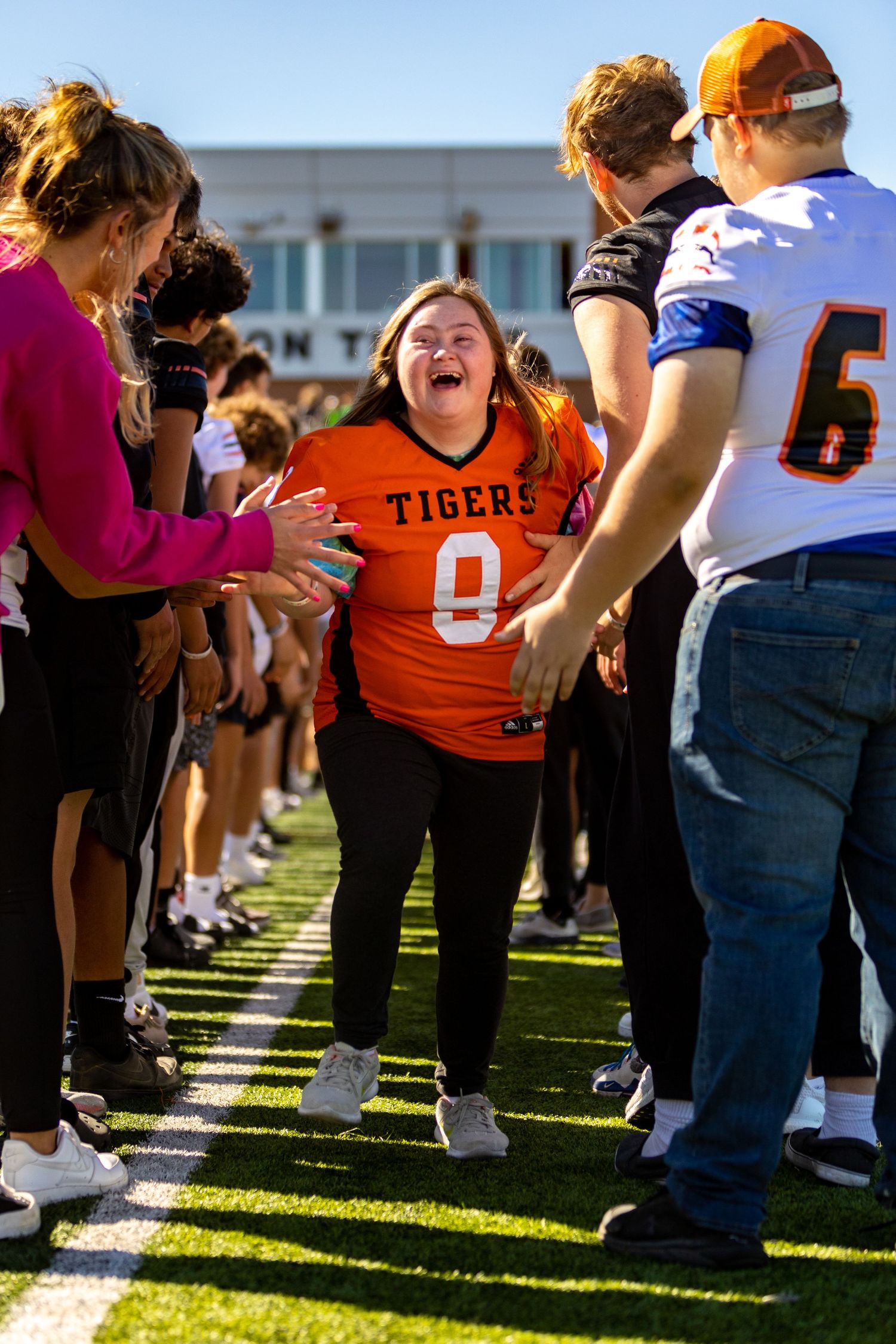 Students make the tunnel of high fives for special needs students