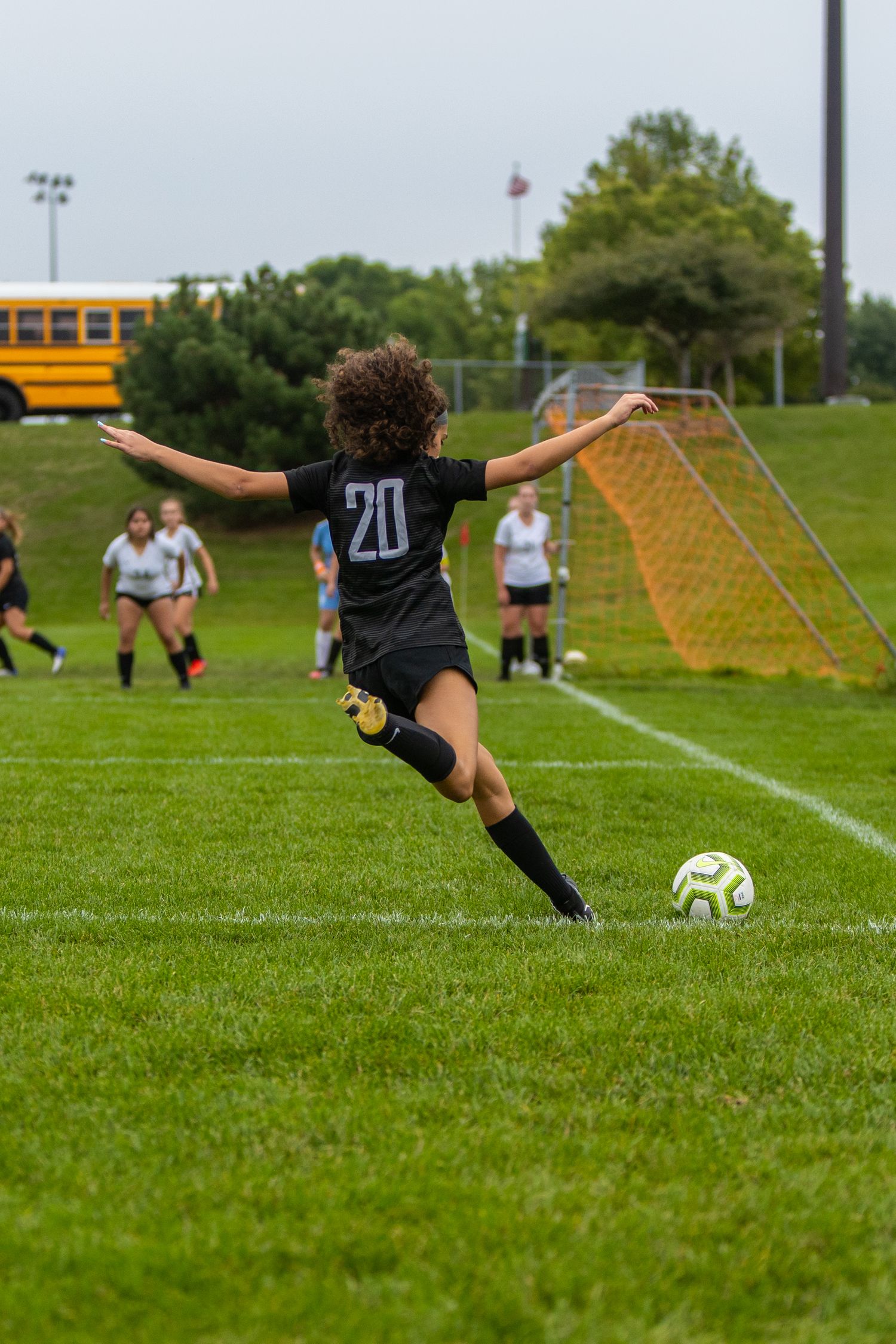 eastview high school girls soccer player frozen mid-kick from the corner