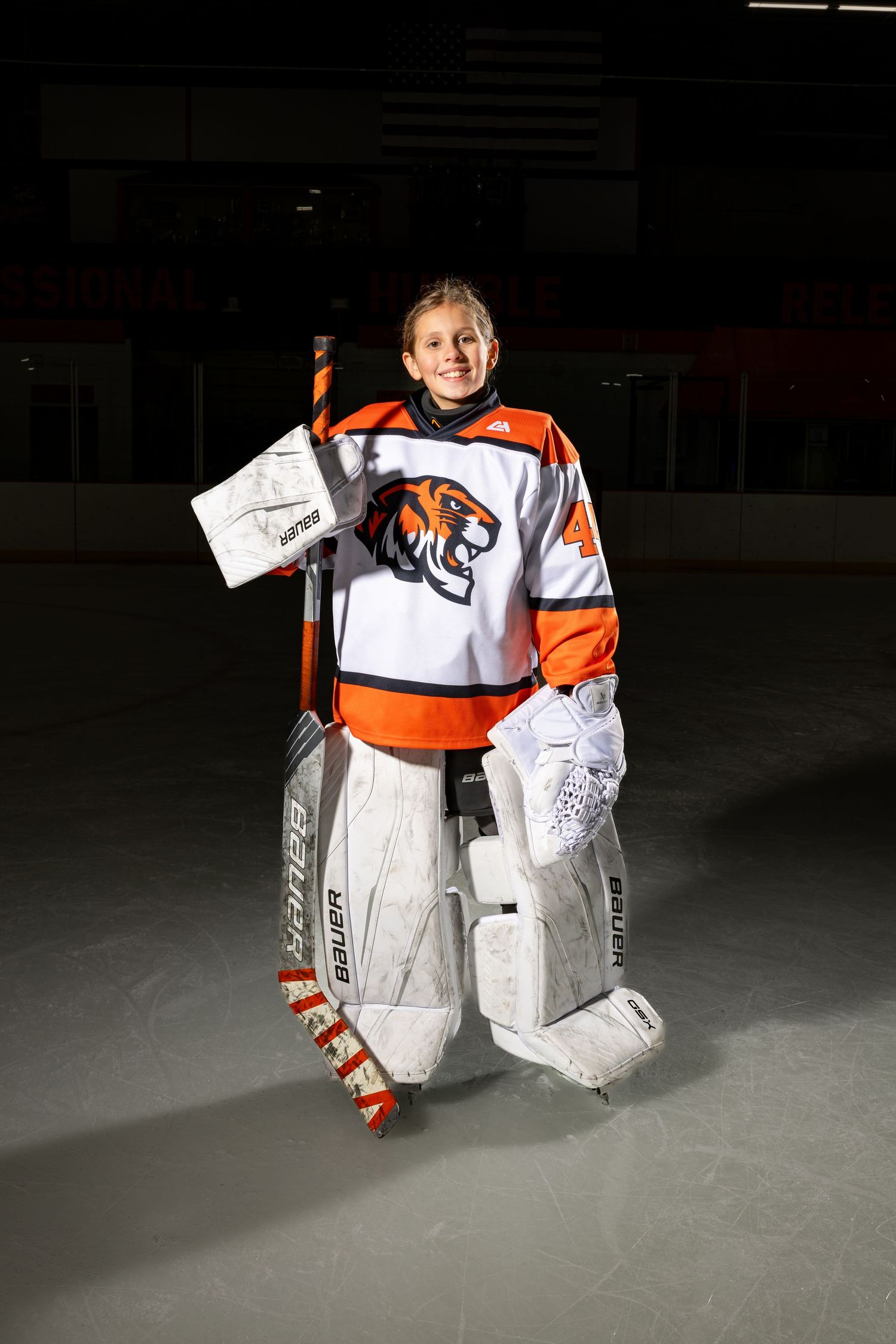 Farmington Tigers girls youth hockey goalie stands tall in her pads with her stick for media day