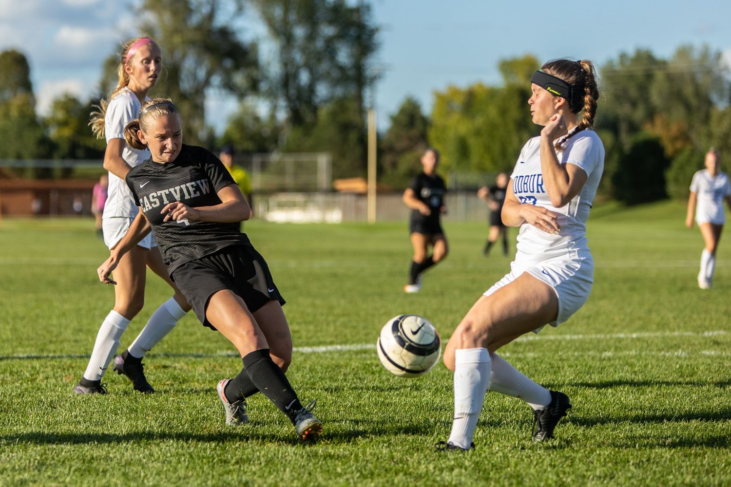 eastview high school girls soccer player passes ball to teammate