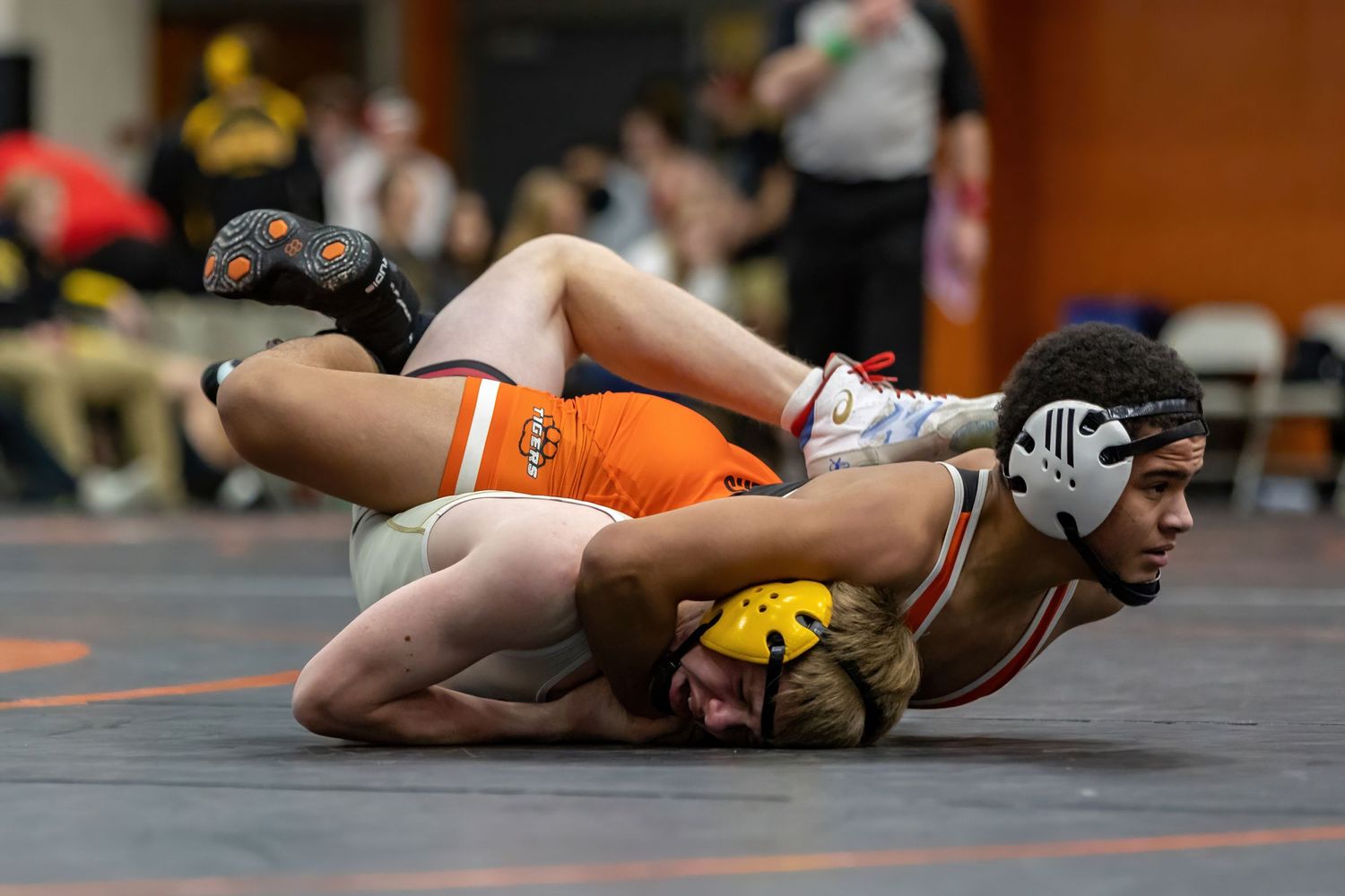 Farmington Tigers wrestler holds his opponent to score some points