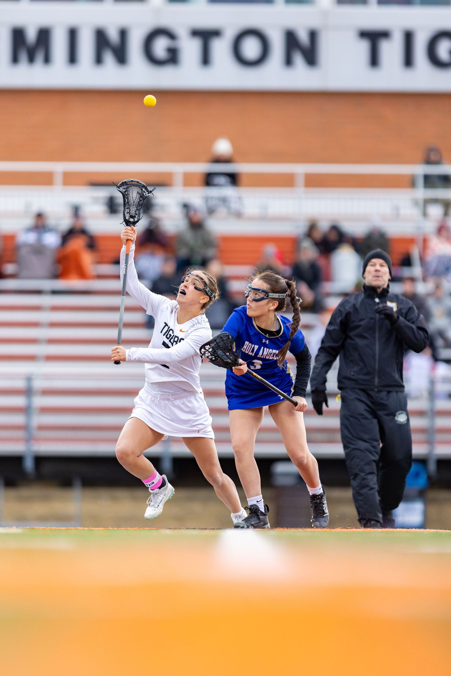 Farmington Tigers girls lacrosse player winse the face off draw against her opponent