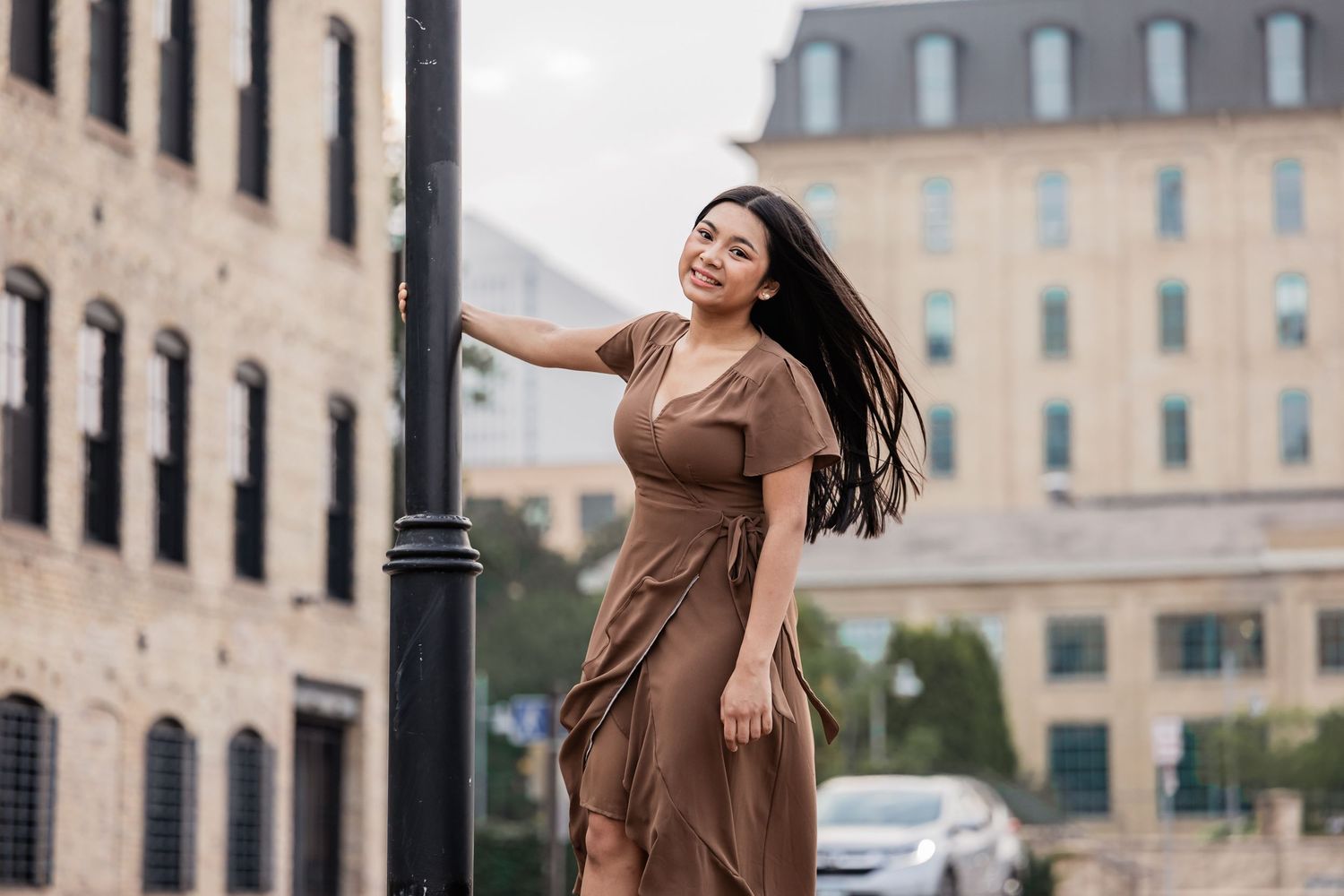 Nina swings around a light pole in downtown Minneapolis at Mill Ruins Park
