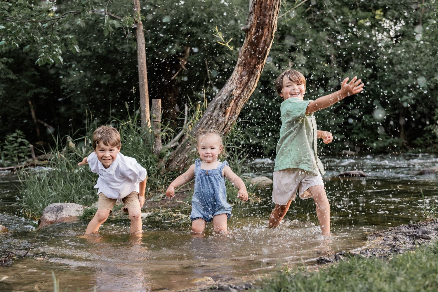 Macias children splash in the creek leading to Minnehaha Falls on a warm fall evening