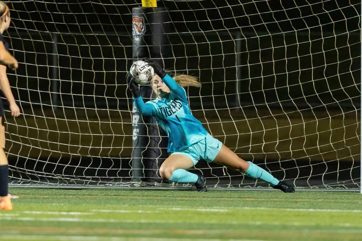 Farmington Tigers girls soccer goalie dives to make a huge save