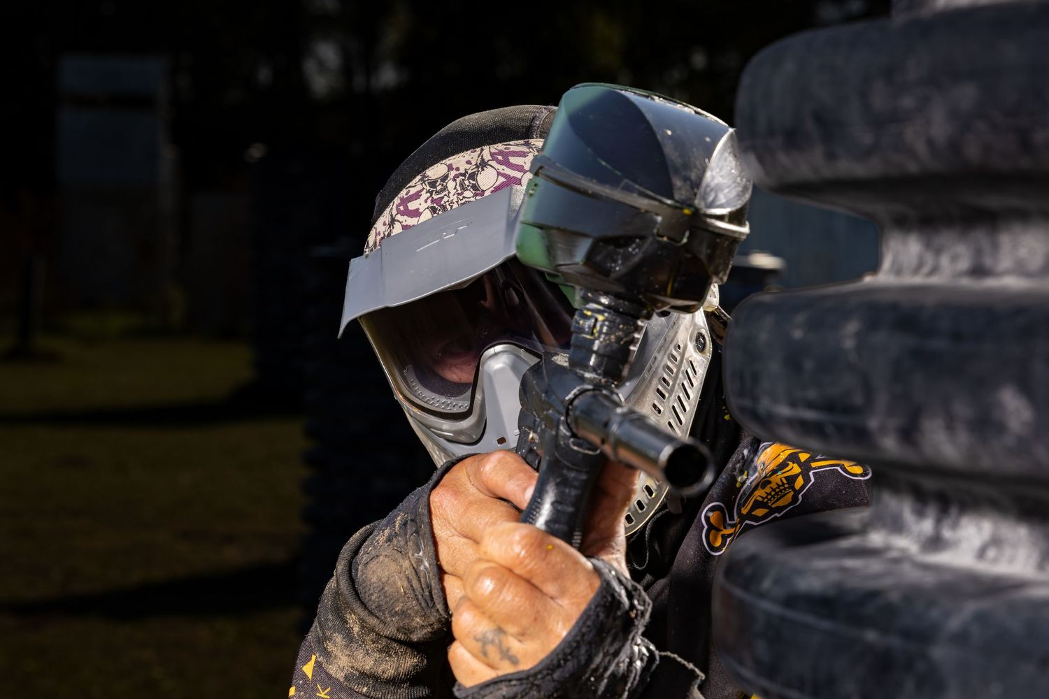 Havoc paintball team player pops out from the side of the bunker to shoot his opponent
