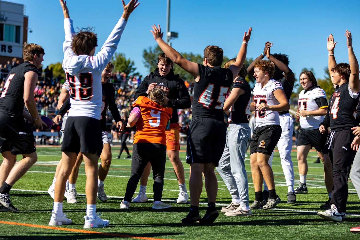 Students make the tunnel of high fives for special needs students
