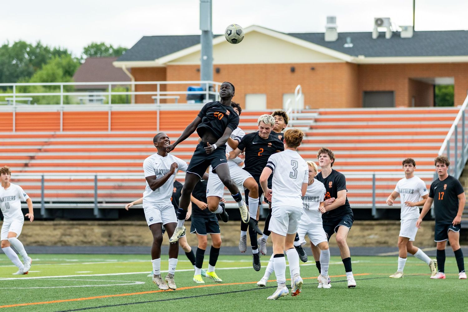 Farmington Tigers boys soccer player goes up for the header on a corner kick to score a goal