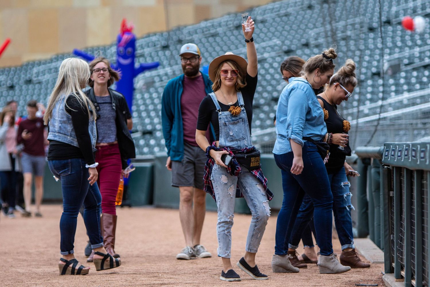Young woman enjoys her beer as she walks the field at Target Field in Minneapolis