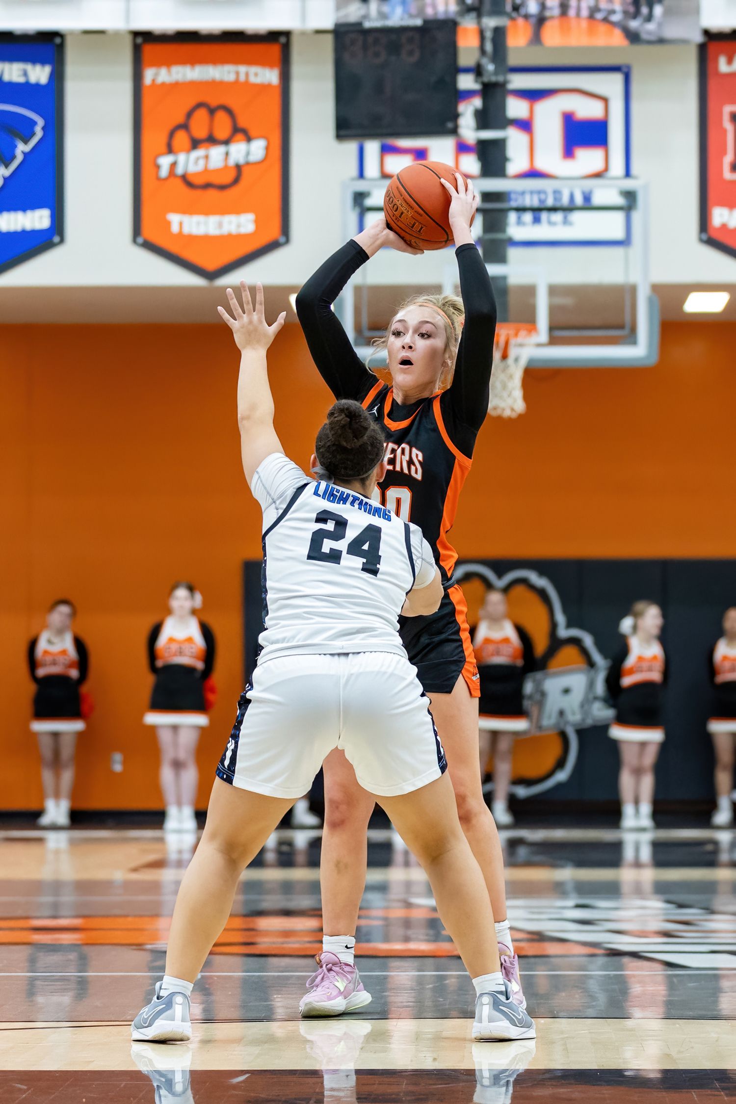 Farmington Tigers girls basketball player looks for a pass over a defender