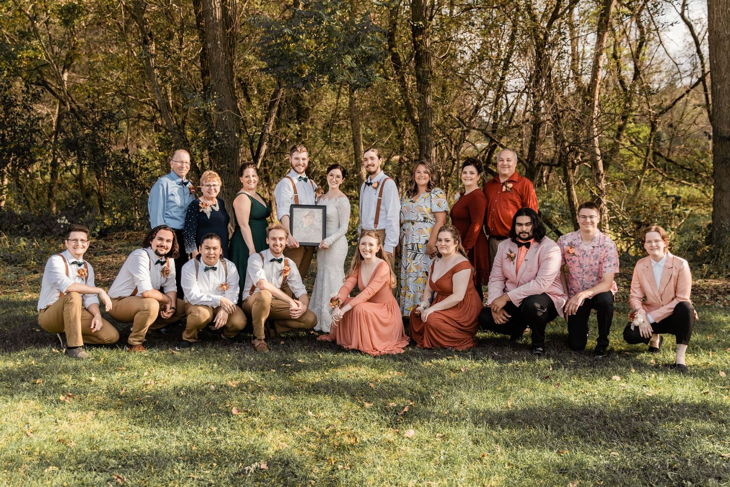 bride and groom with both families and wedding party
