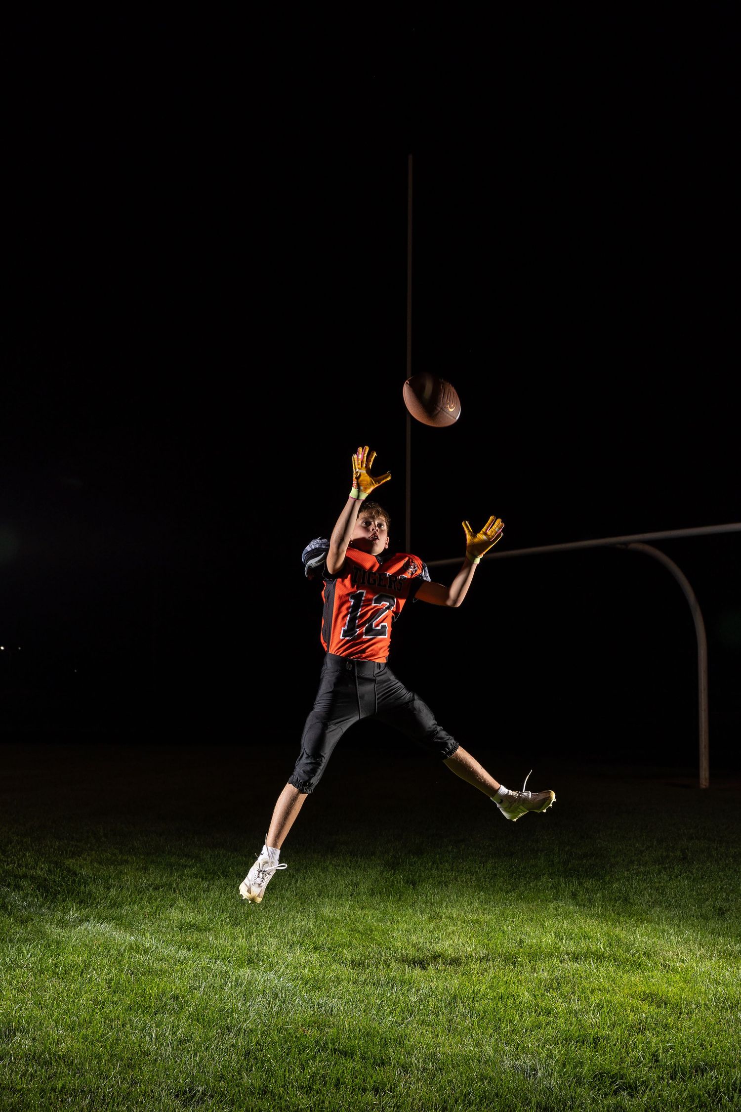Farmington Tigers youth football player dynamic lighting sportrait twin cities sports photographer Henry Christensen