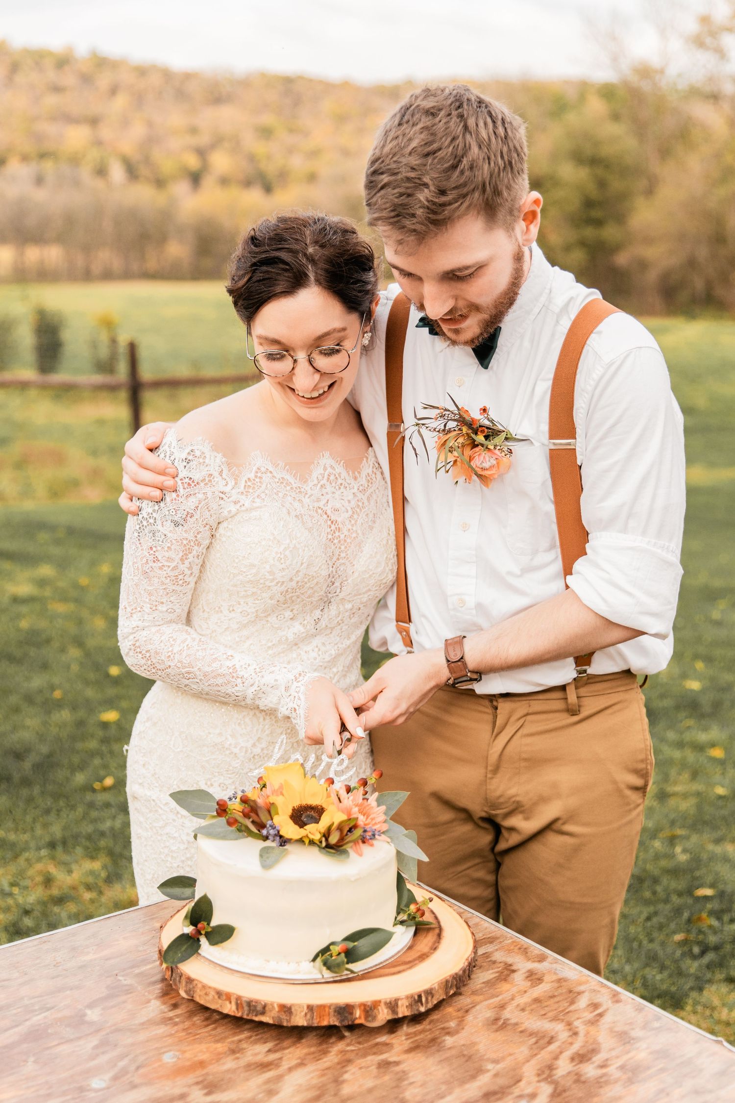 bride and groom cutting their cake together