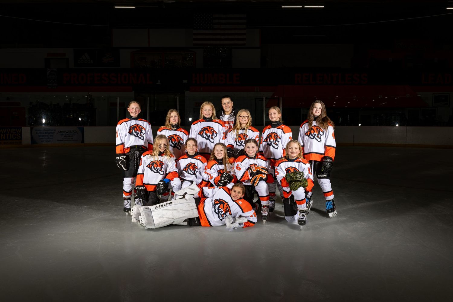 Farmington Tigers girls youth hockey team pose on the ice for media day