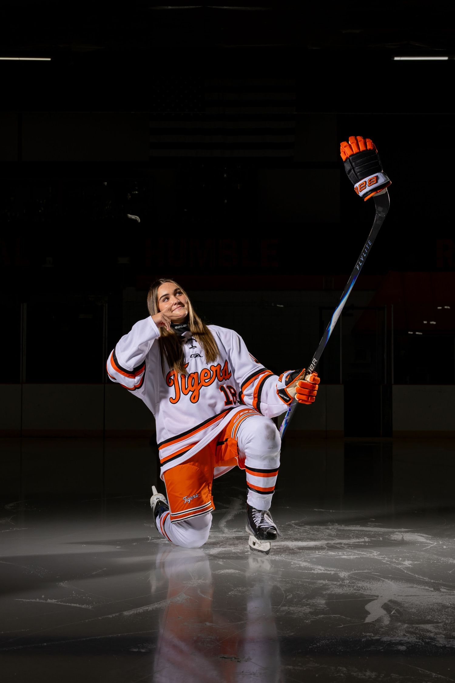 Farmington Tigers girls hockey player pretends she's taking a selfie for her media day pose