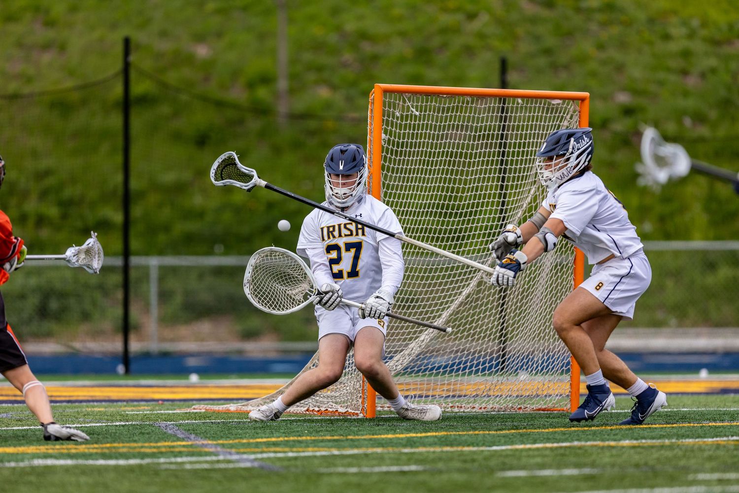 Rosemount Irish boys lacrosse goalie makes a save on a low shot