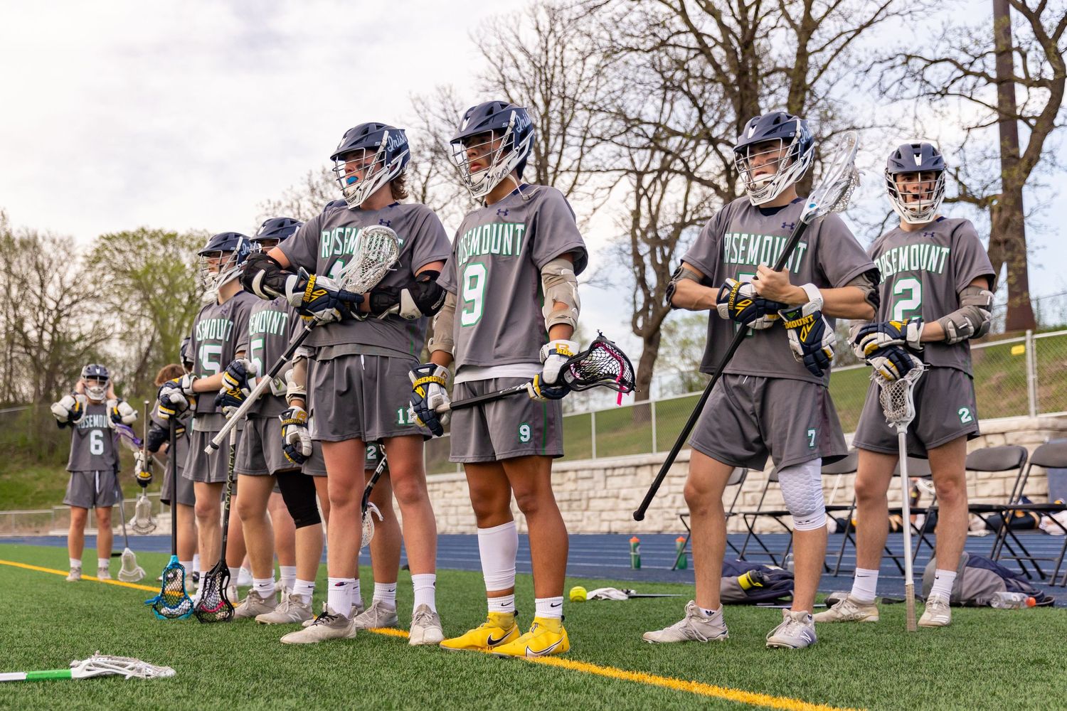 Rosemount Irish lacrosse players watching the game from the sidelines