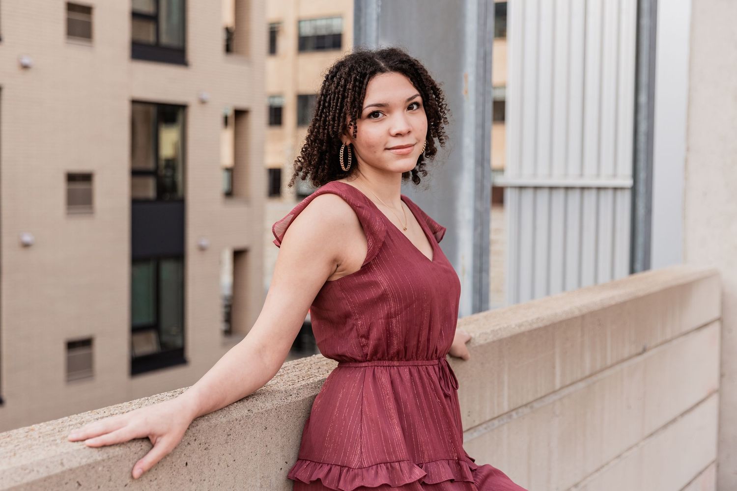 Tabi confidently poses against a wall atop a parking structure in Minneapolis for her senior photos