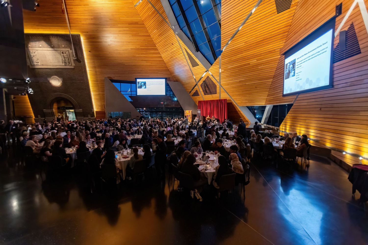 Awards dinner wide angle shot of the entire event attendees at tables listening to the presenter