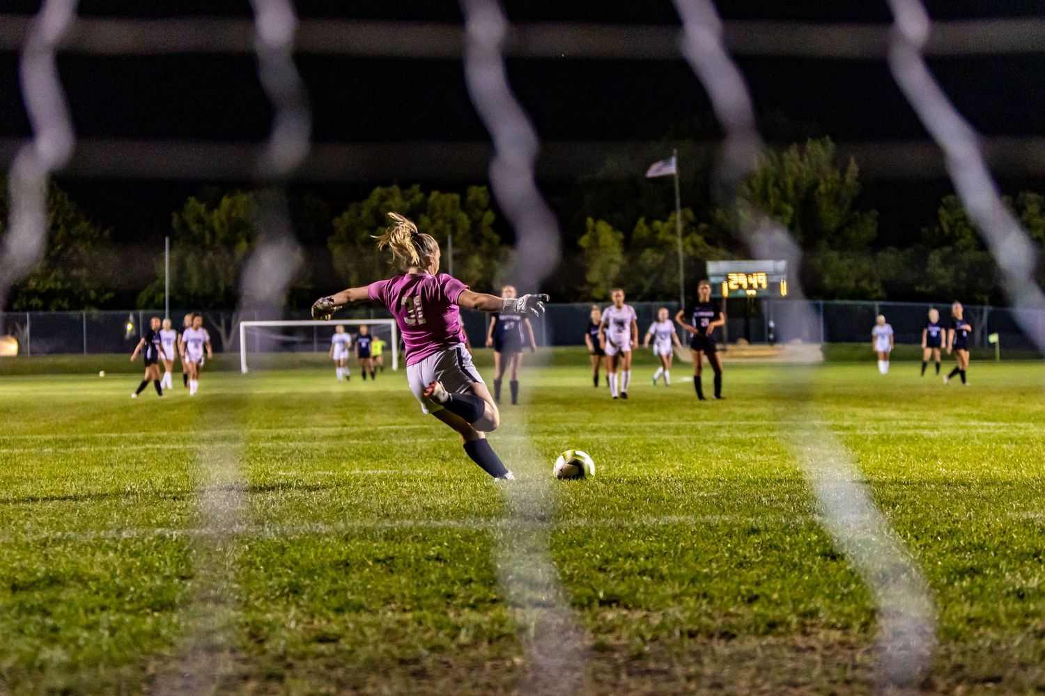 eastview high school girls soccer goalie takes free kick from behind net