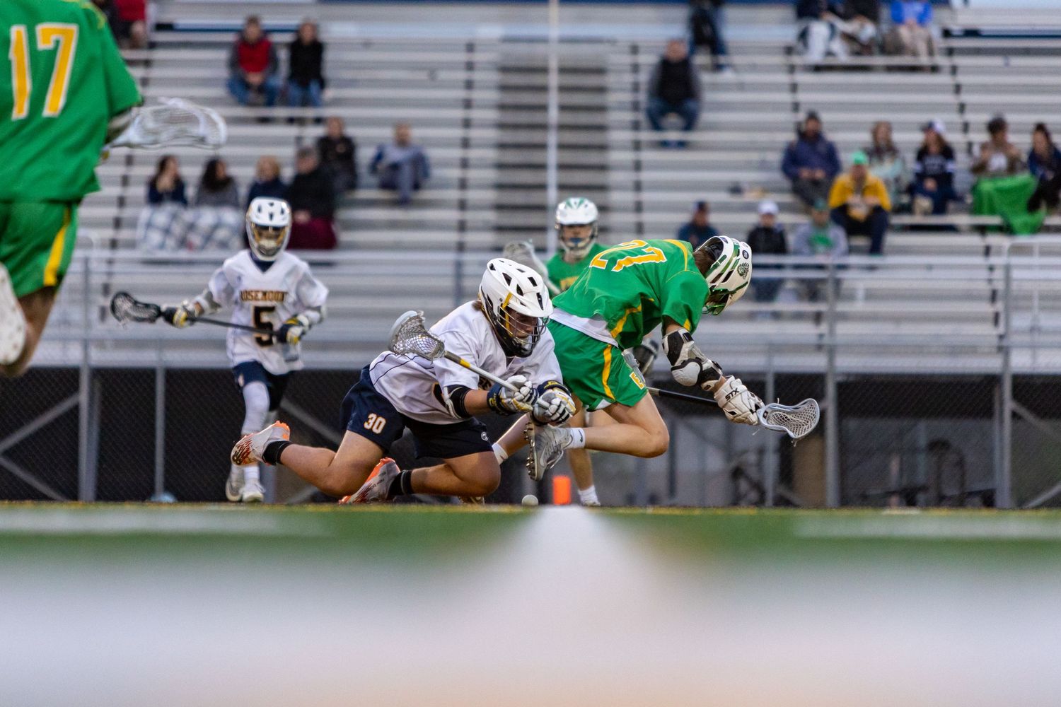 Rosemount Irish lacrosse player winning the faceoff draw