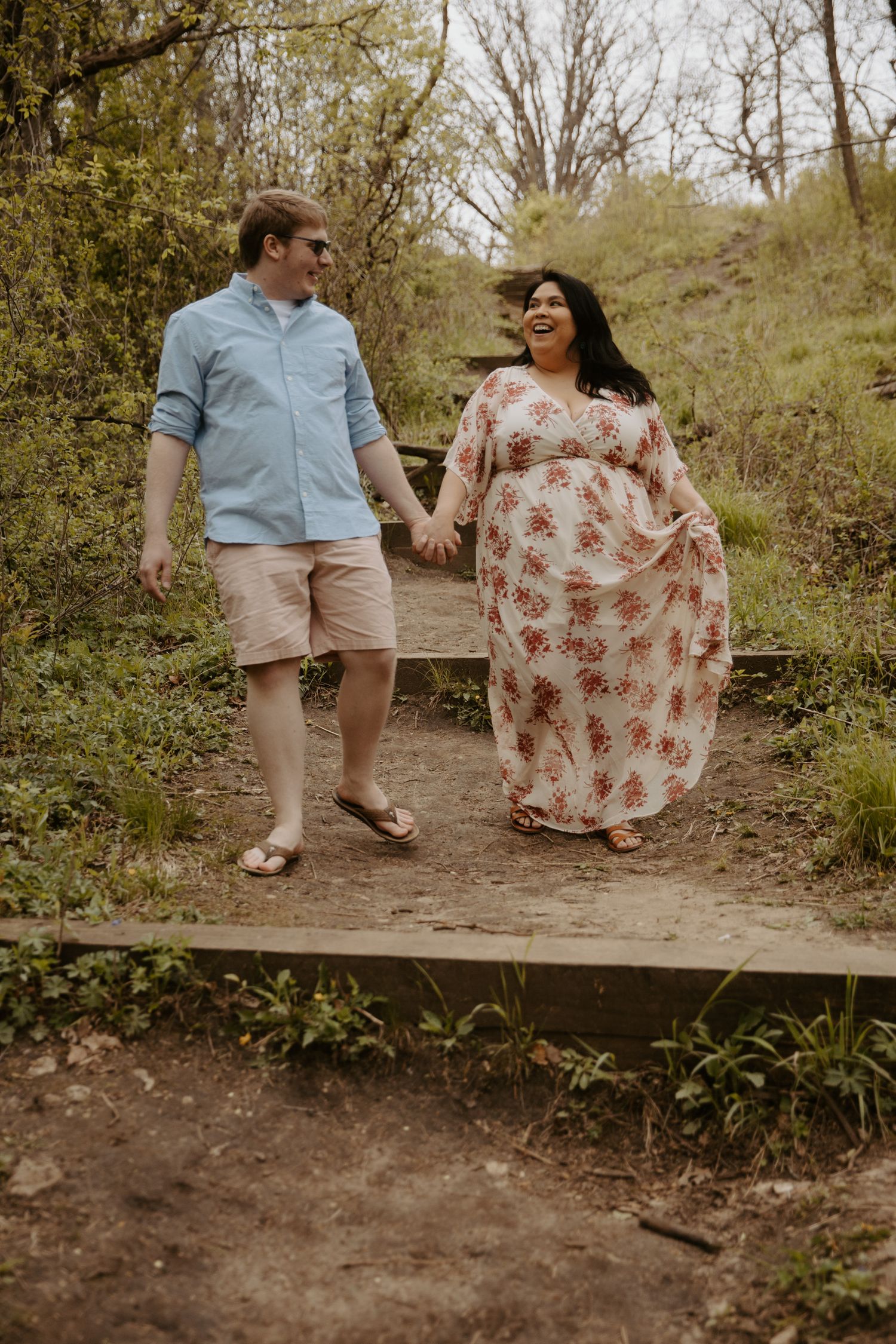 Young couple walks down dirt and rock covered hill