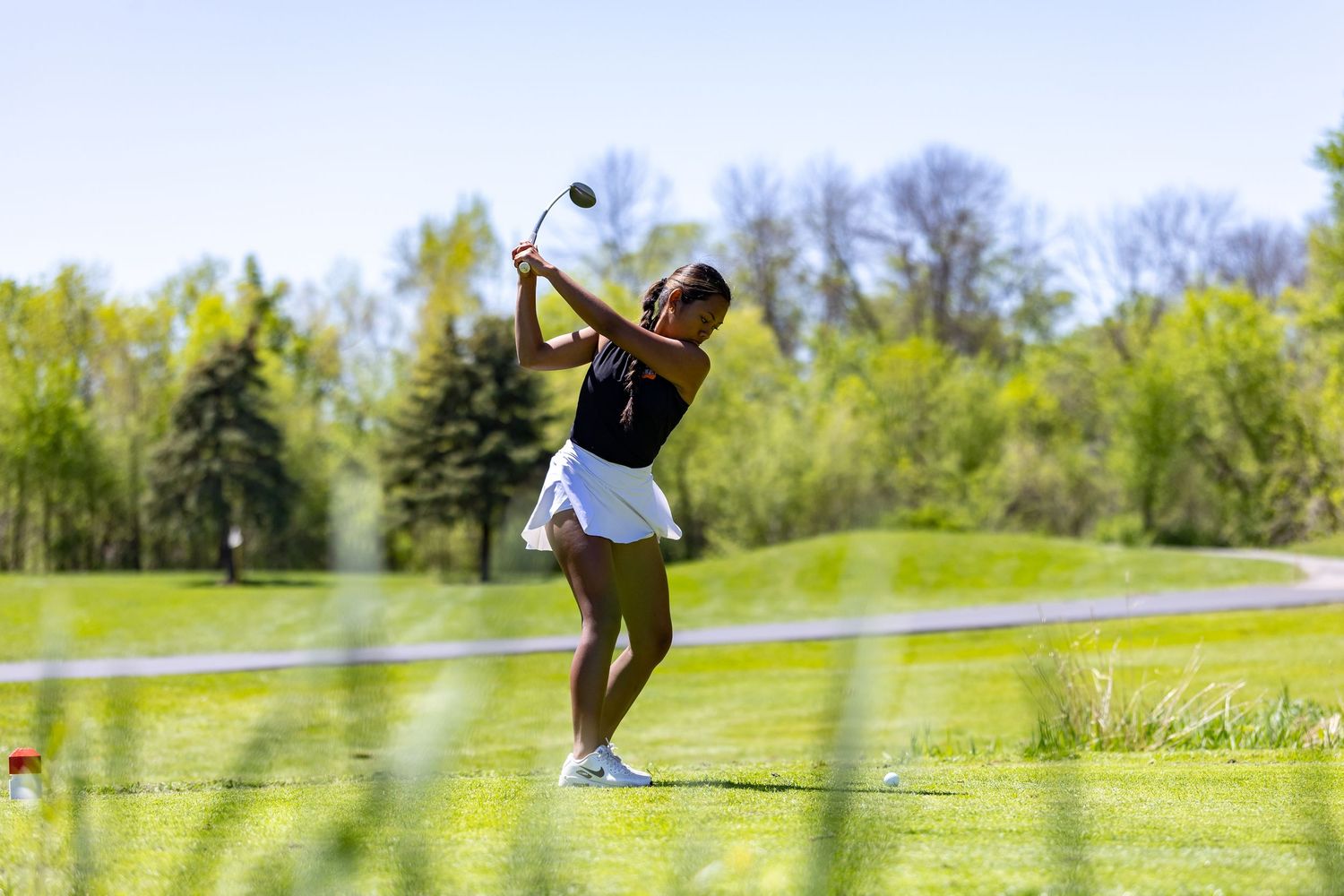 Farmington Tigers girls golfer takes her shot from the middle of the fairway