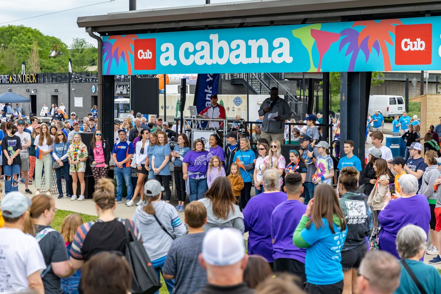 Local news anchor gives a speech to attendees of the Crohn's and Colitis fun run at CHS Field