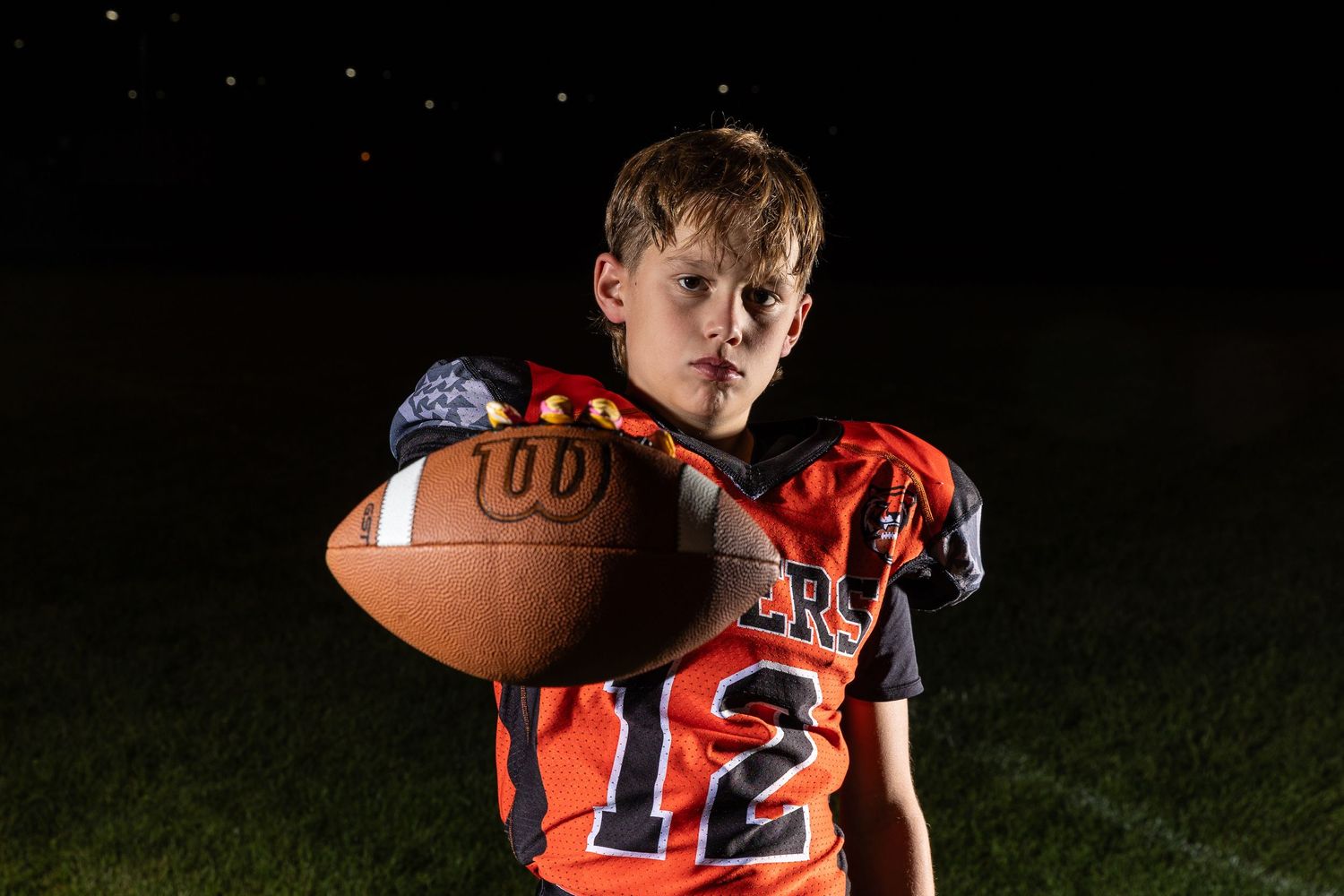 Farmington Tigers youth football player dynamic lighting sportrait twin cities sports photographer Henry Christensen
