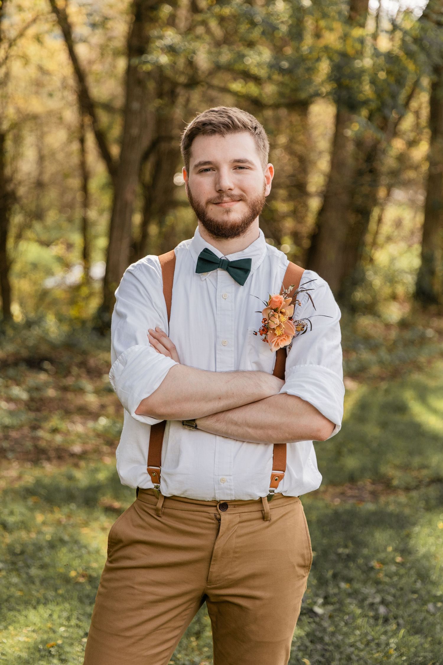 groom shows off his casual attire with a little attitude