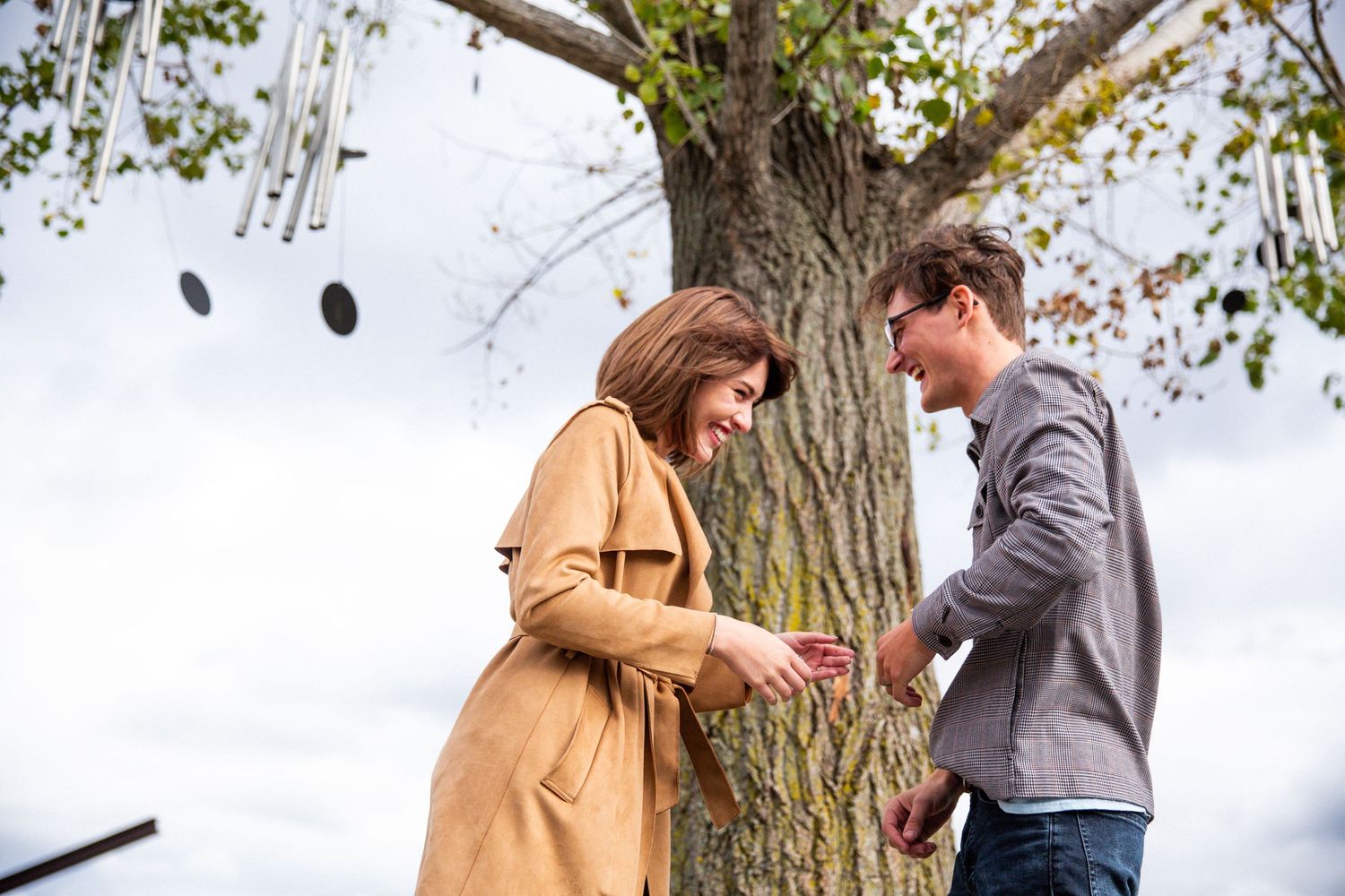 young engaged couple laughing during their session