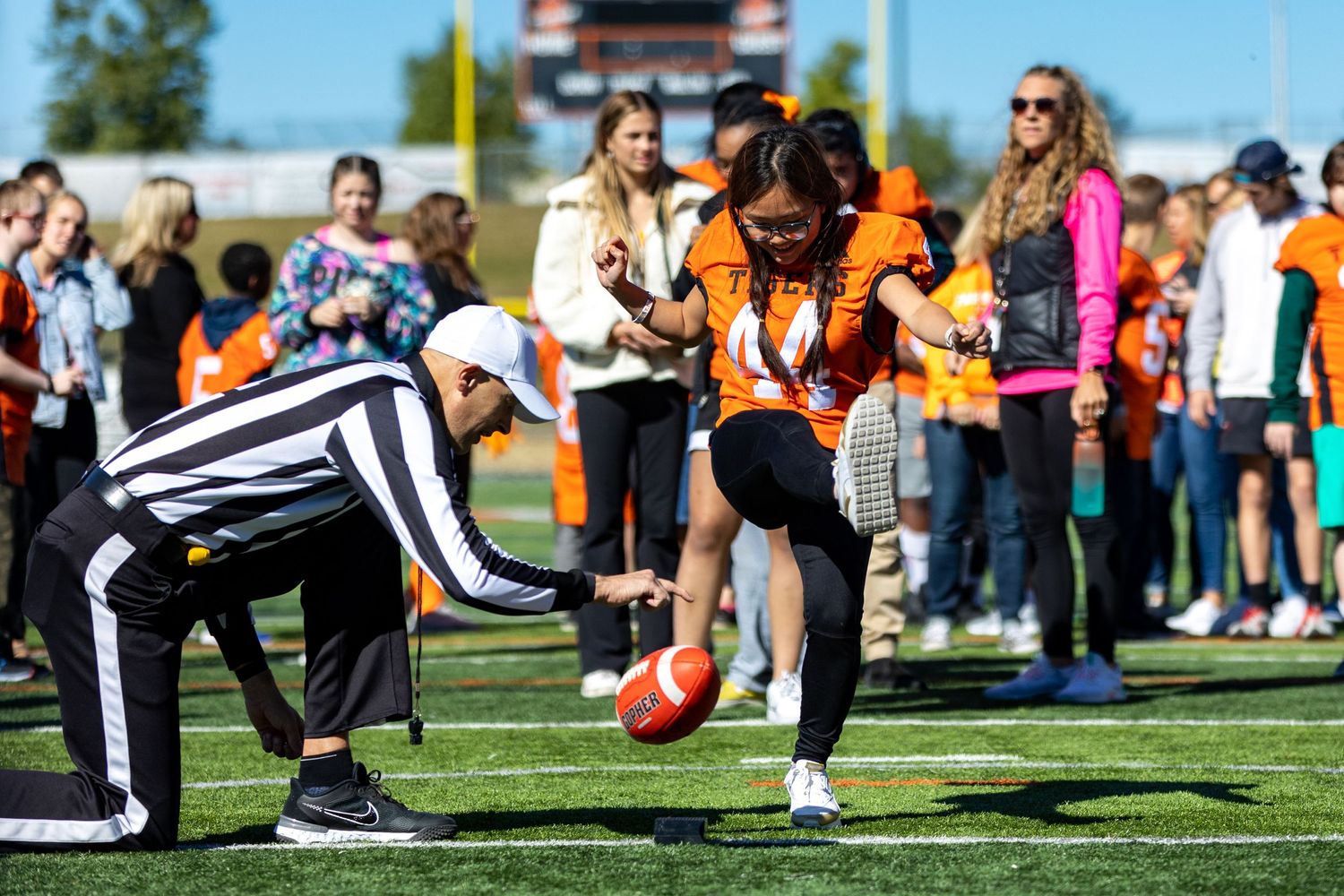 Students make the tunnel of high fives for special needs students