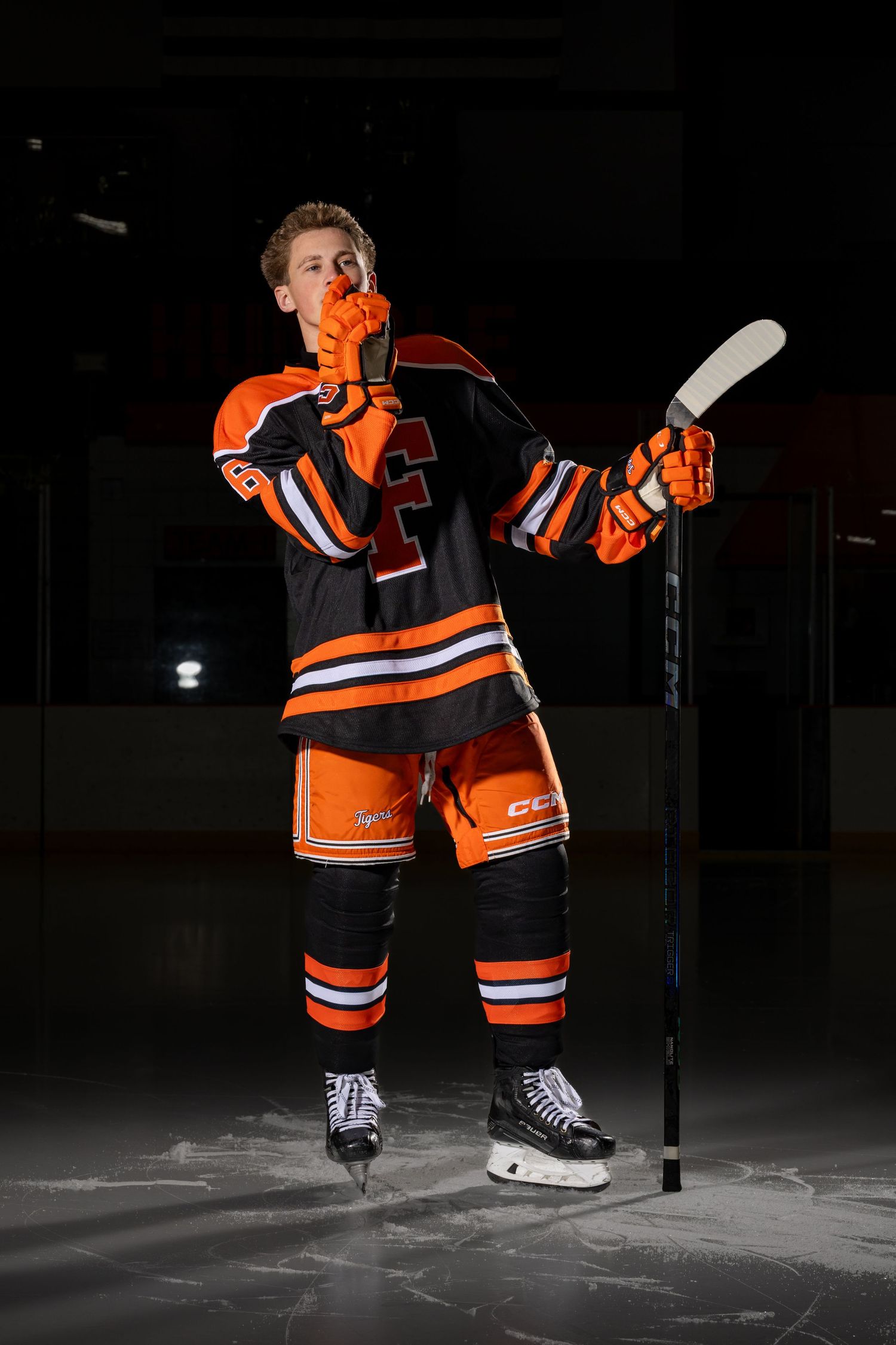 Farmington Tigers boys hockey player does his best hush celebration pose for media day
