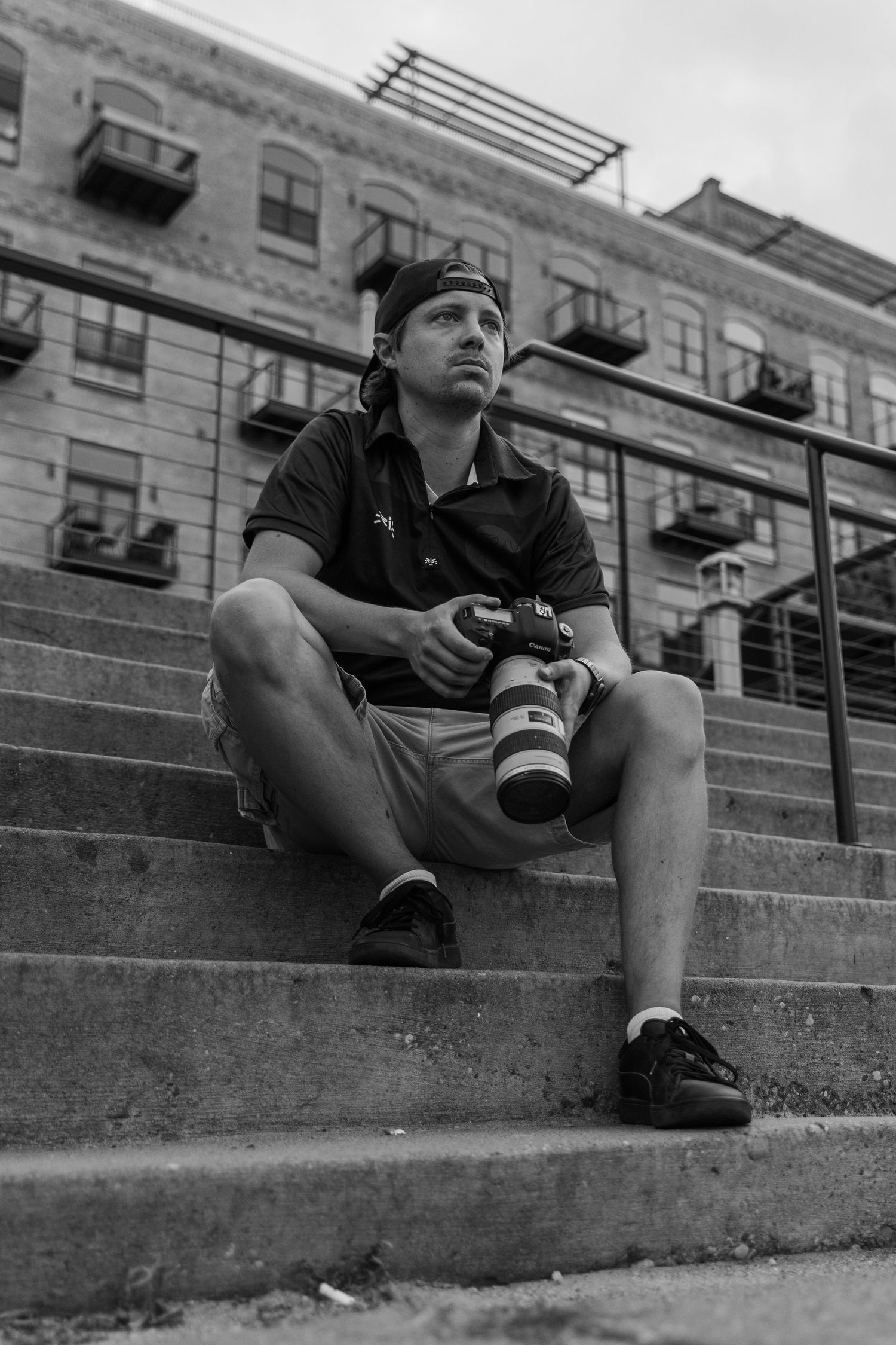AFRAY Photo sits on a staircase at Stone Arch Bridge
