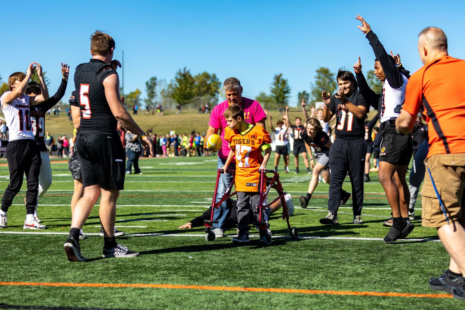 Students make the tunnel of high fives for special needs students