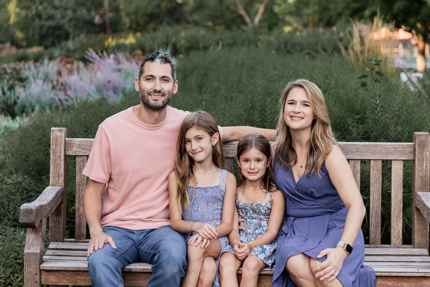 Iliev family snuggles up on a wooden bench at Centennial Lakes Park in Edina
