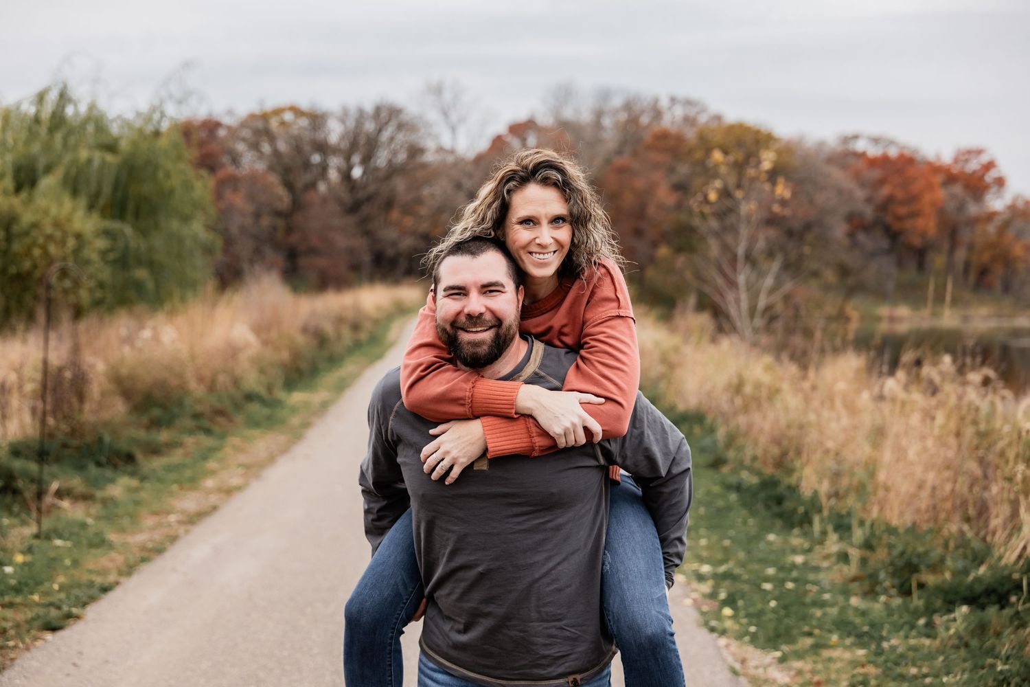 Brandon puts his wife Brittany on his back near the lake at Whitetail Woods
