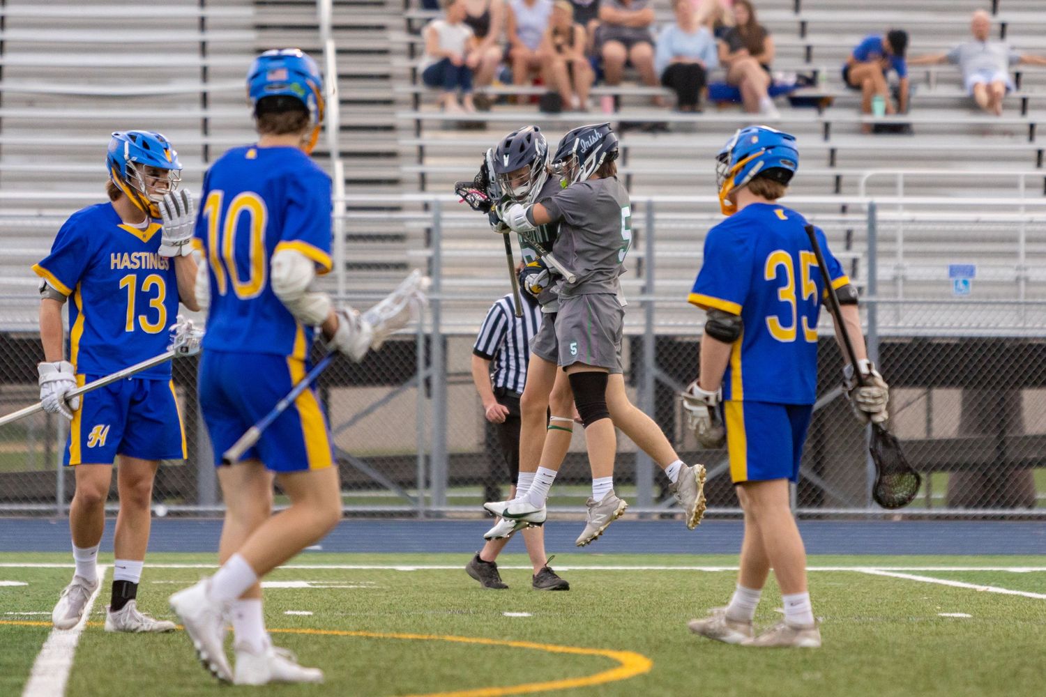 Rosemount Irish lacrosse players celebrate scoring a goal