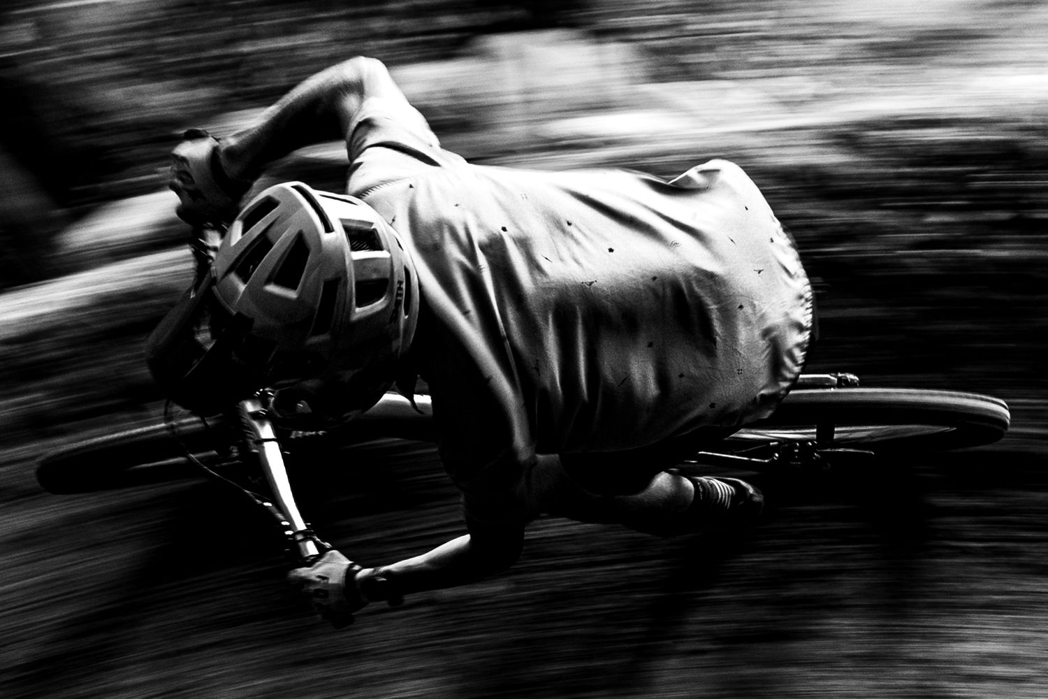 A monochromatic sequence of blurred action shots shows breakdancing moves performed on the ground.