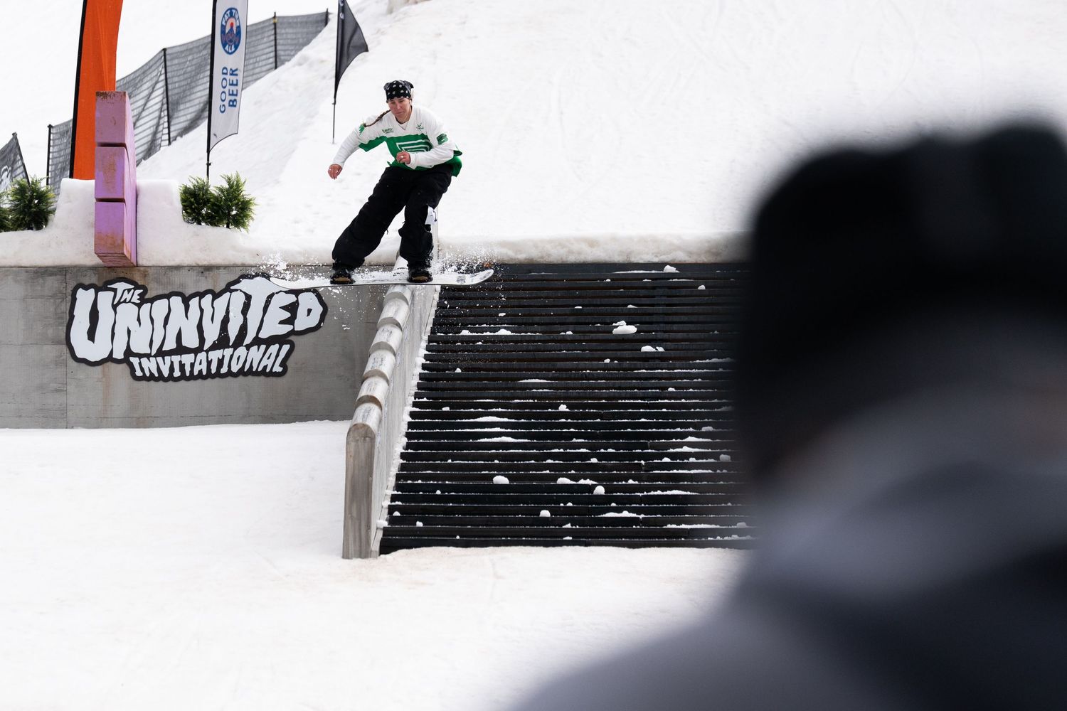 Snowboarder performs a rail grind trick at The Uninvited Invitational winter sports competition.