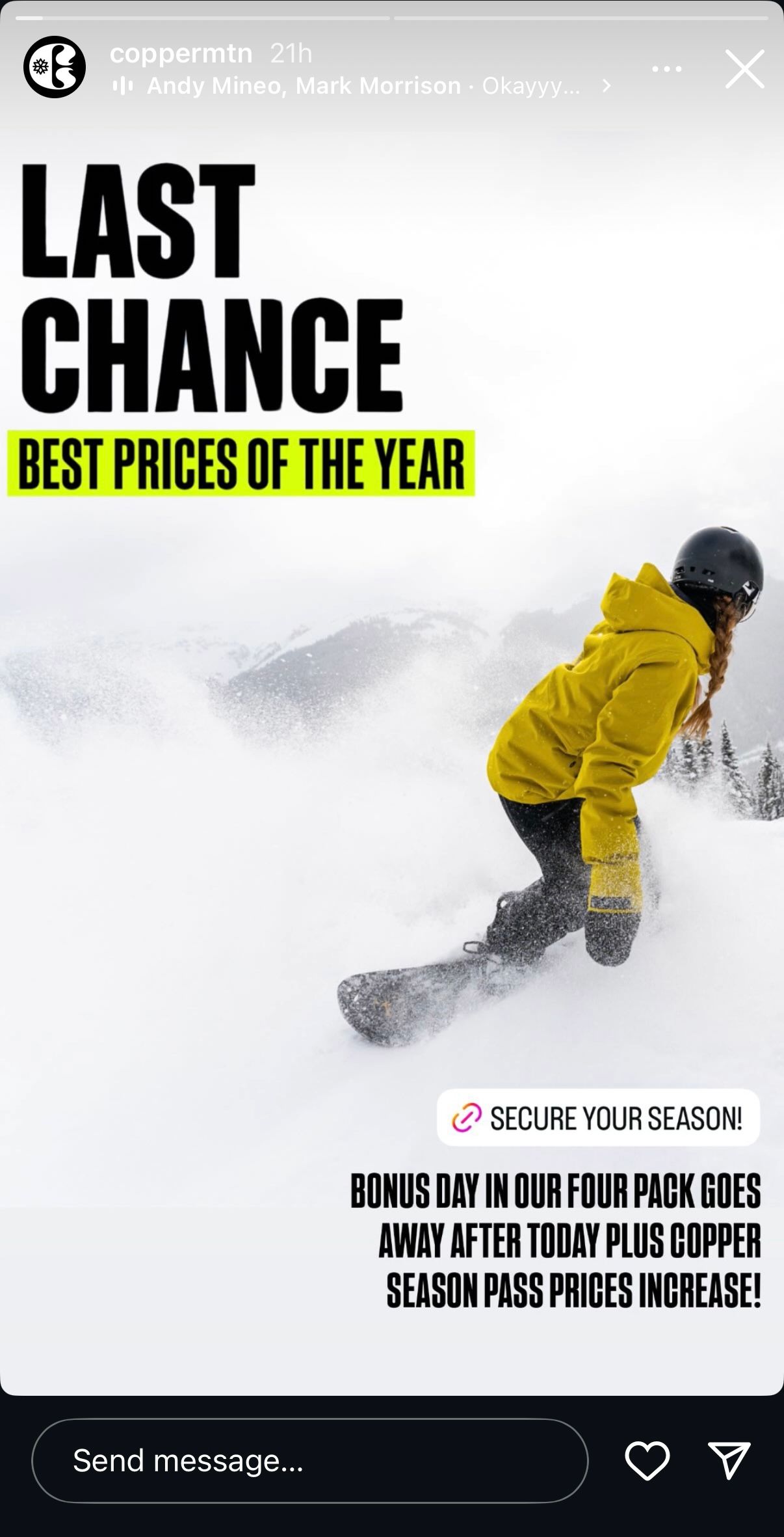 Snowboarder in yellow jacket carves through deep powder snow against white winter mountain backdrop.
