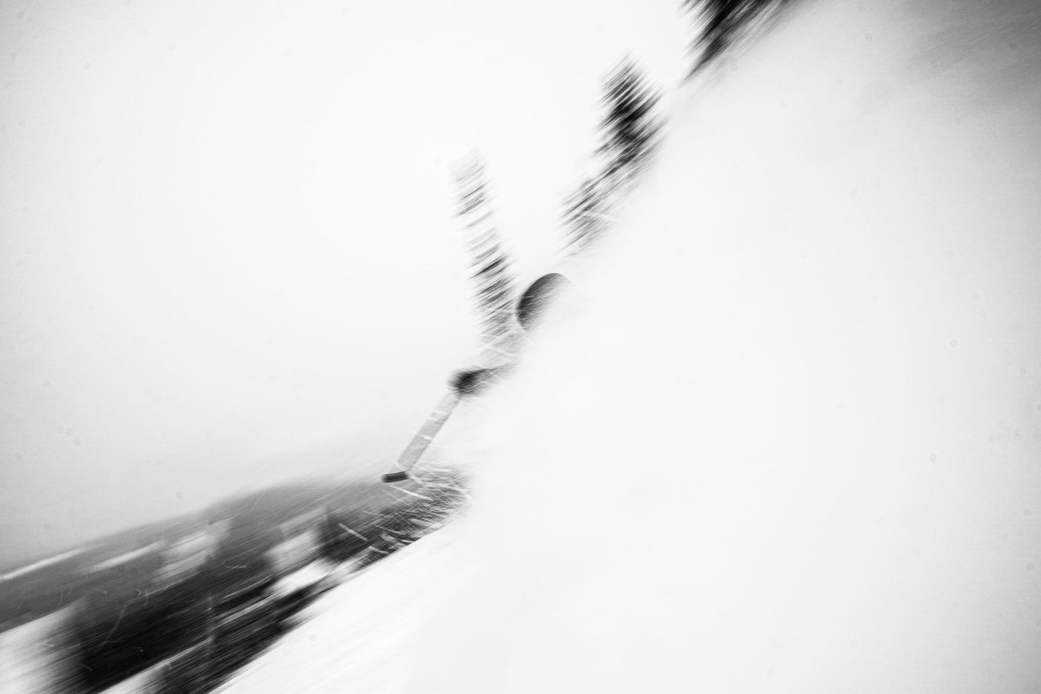 Abstract motion blur capture of skier in black and white.