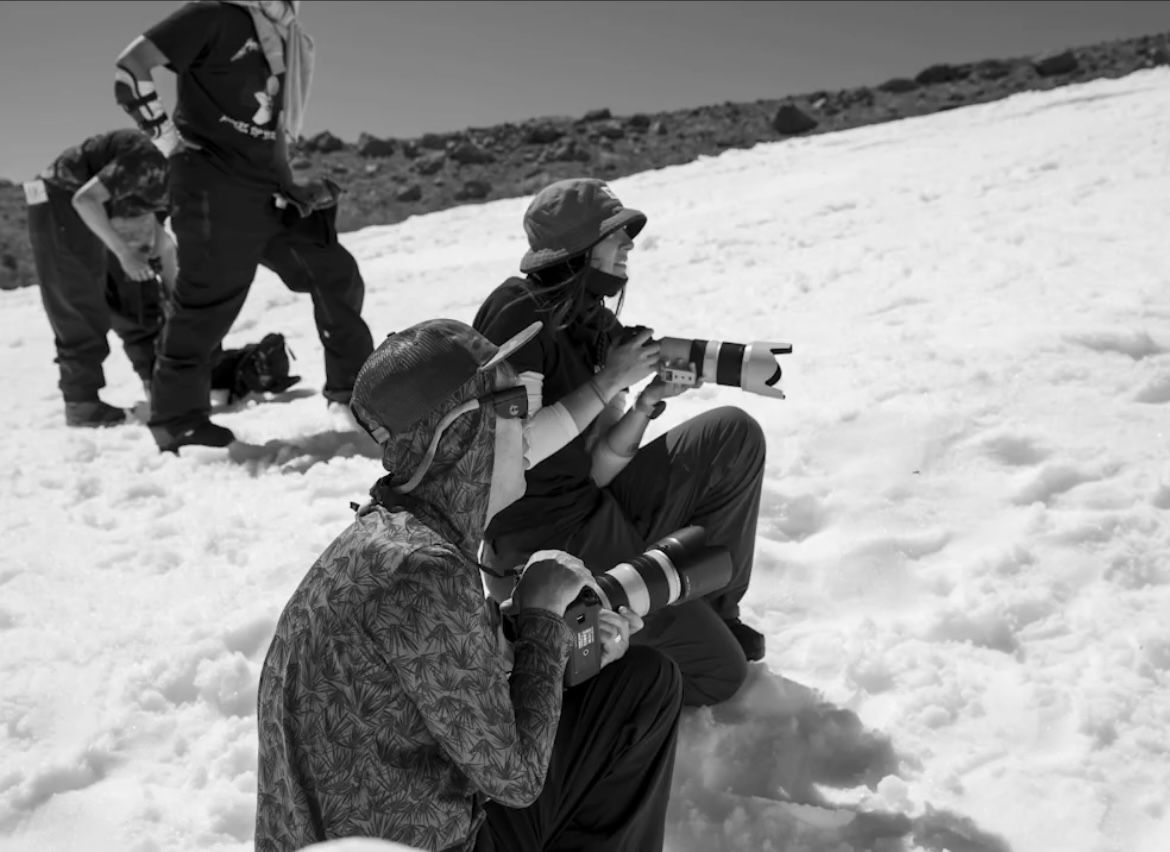 A series of snowboarding action shots showing dynamic jumps and tricks against a snowy winter landscape background.